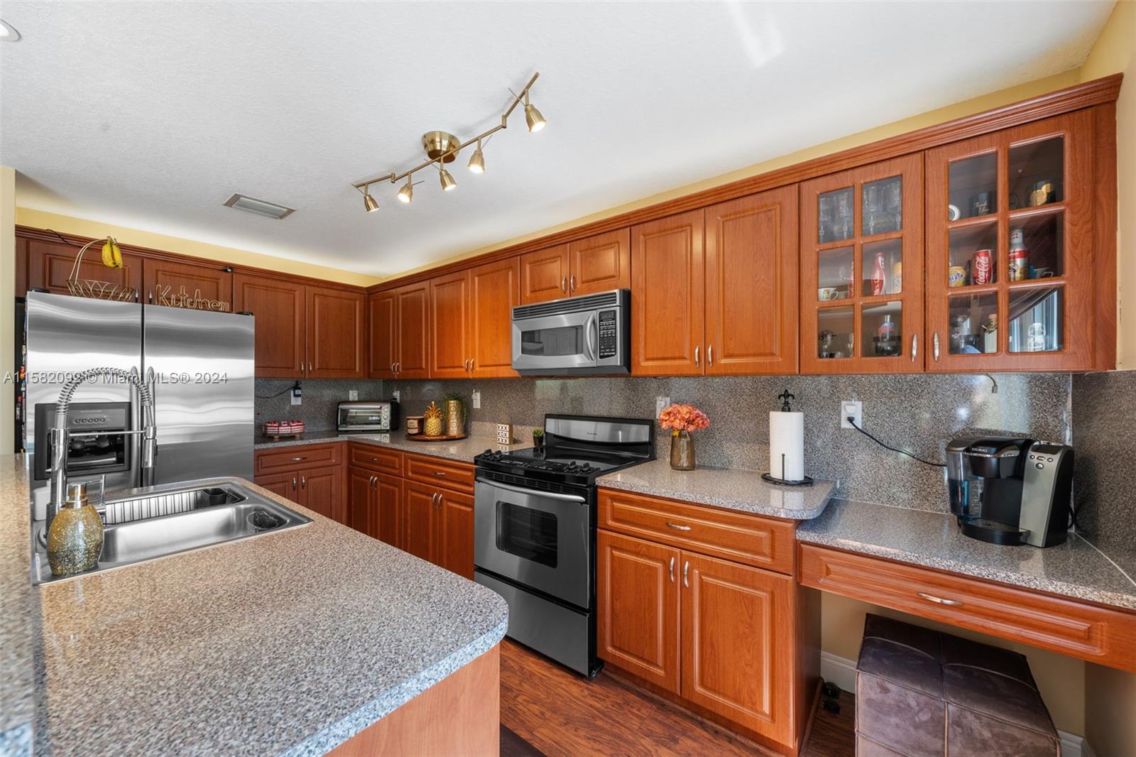 3091 Southwest 153rd Path Miami, FL 33185 - Photo 13 of 34 a kitchen with stainless steel appliances granite countertop a sink stove and refrigerator