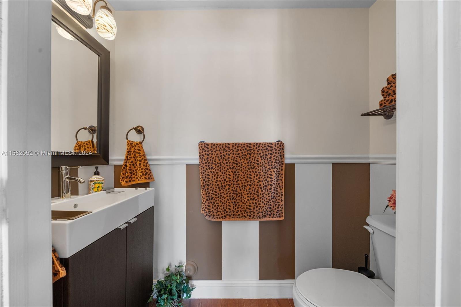 3091 Southwest 153rd Path Miami, FL 33185 - Photo 14 of 34 a bathroom with a sink vanity mirror and toilet