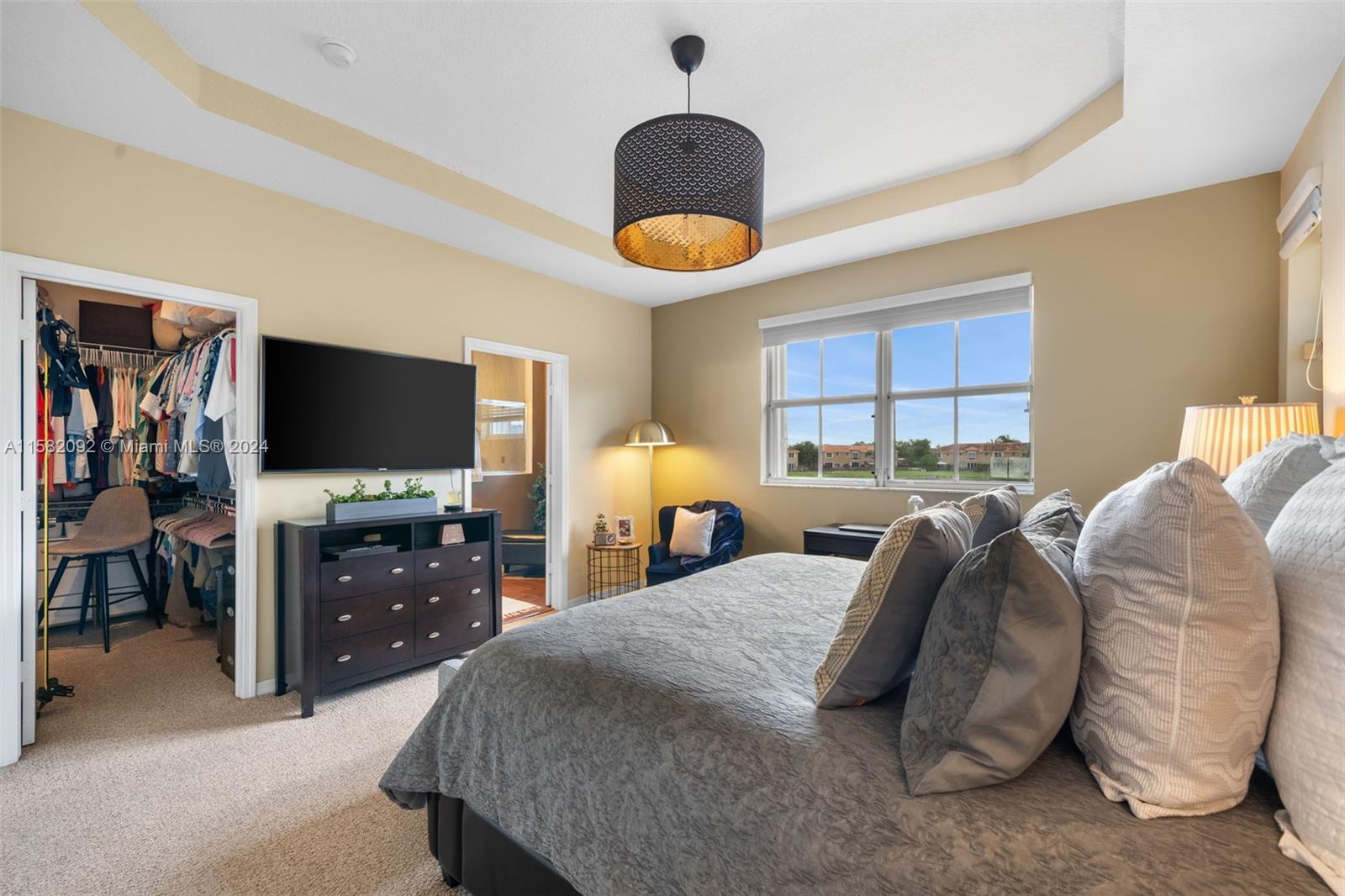 3091 Southwest 153rd Path Miami, FL 33185 - Photo 21 of 34 a bedroom with a bed and a flat tv screen on dresser