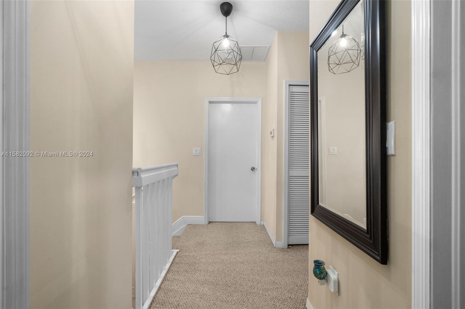 3091 Southwest 153rd Path Miami, FL 33185 - Photo 27 of 34 a view of a hallway with windows and chandelier