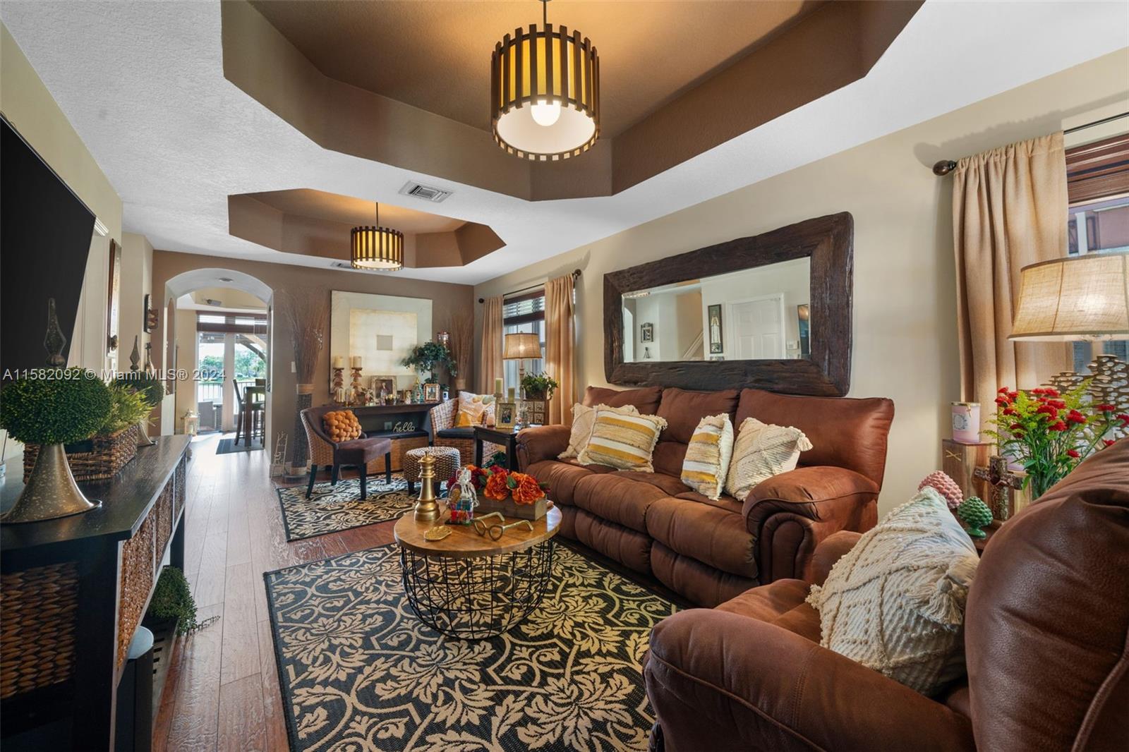 3091 Southwest 153rd Path Miami, FL 33185 - Photo 4 of 34 a living room with furniture dining area and a chandelier
