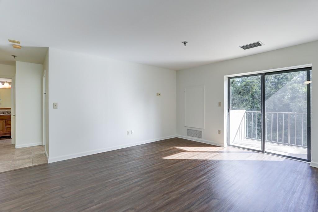 300 Johnson Ferry Road, Unit A405 Atlanta, GA 30328 - Photo 2 of 15 a view of an empty room with wooden floor and a window