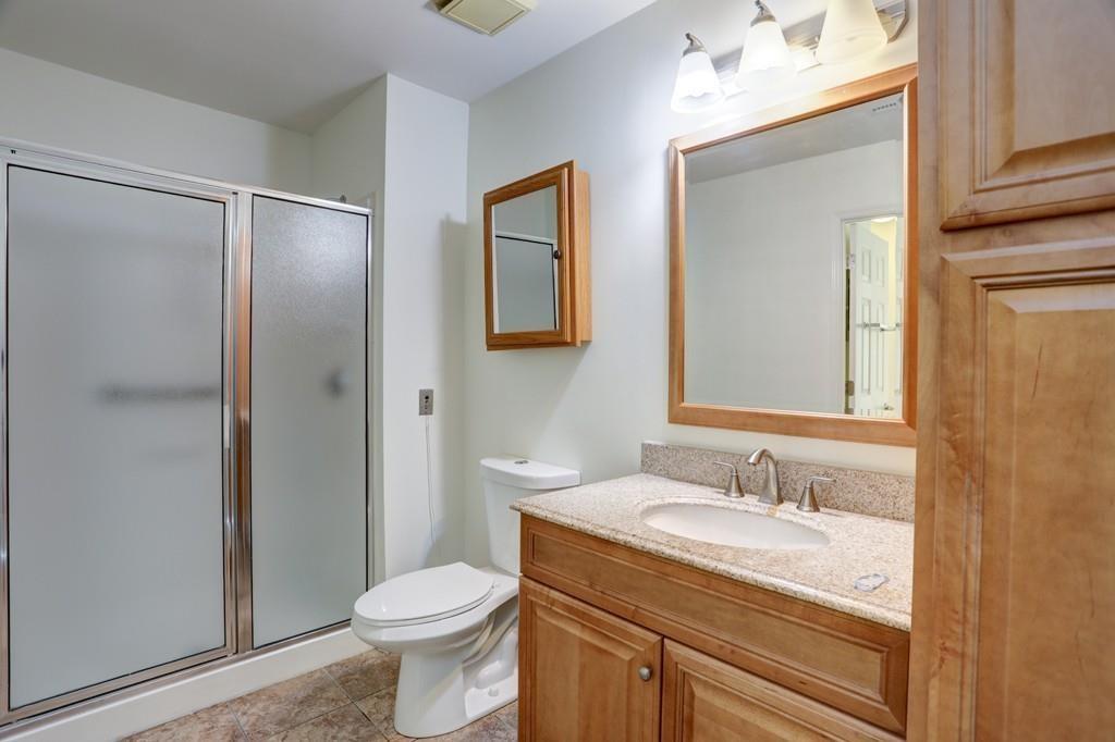 300 Johnson Ferry Road, Unit A405 Atlanta, GA 30328 - Photo 7 of 15 a bathroom with a granite countertop sink toilet and shower