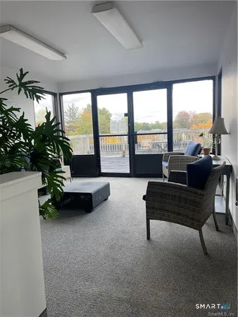 a living room with furniture and a floor to ceiling window