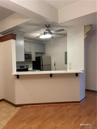a view of kitchen with cabinets and wooden floor