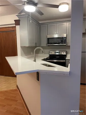 a kitchen with a sink a stove and cabinets