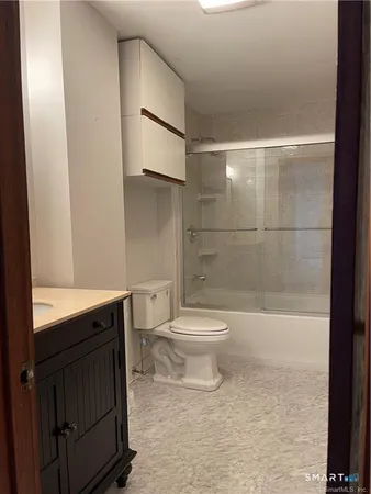 a bathroom with a toilet a sink and shower