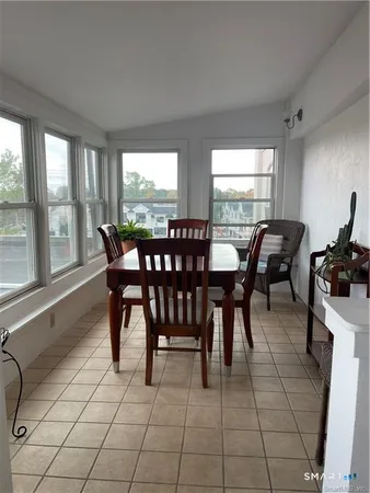a view of a dining room with furniture and window