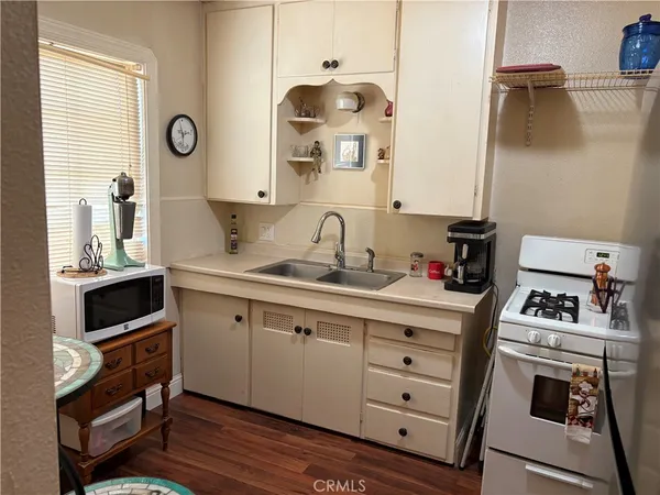 a kitchen with cabinets and wooden floor
