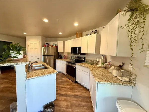 a kitchen with sink refrigerator and cabinets
