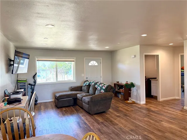 a living room with furniture window and wooden floor