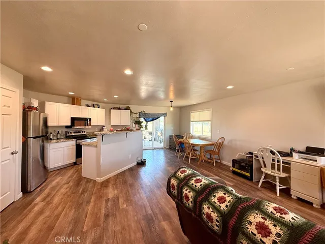 a living room with furniture and kitchen view