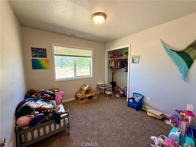 a bedroom with bed and a window