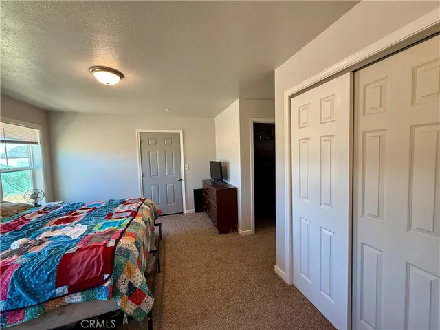 a bedroom with a bed and a closet