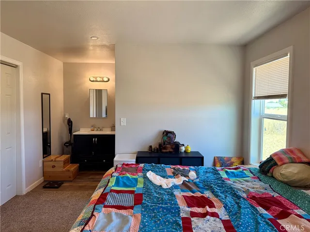 a bedroom with bed and a dresser