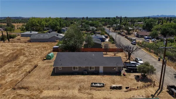 an aerial view of a house with a yard