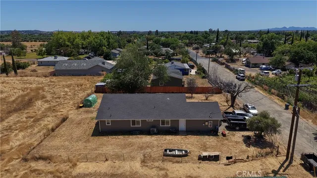 an aerial view of a house with a yard