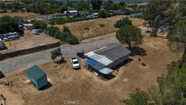 an aerial view of a house with swimming pool and outdoor seating