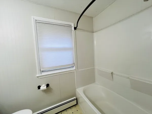 a bathroom with a tub and shower