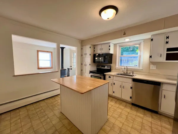 a kitchen with sink cabinets and window