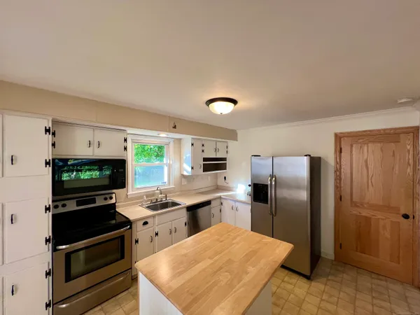 a kitchen with stainless steel appliances granite countertop a refrigerator stove and sink
