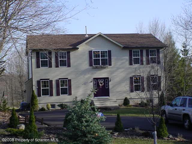 2622 Boulder Road Lake Ariel, PA 18436 - Photo 1 of 9 a front view of a house with garden