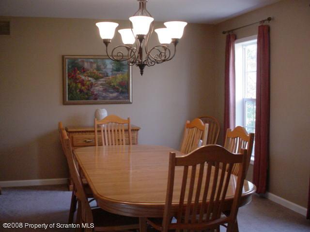 2622 Boulder Road Lake Ariel, PA 18436 - Photo 4 of 9 a view of a dining room with furniture wooden floor and chandelier