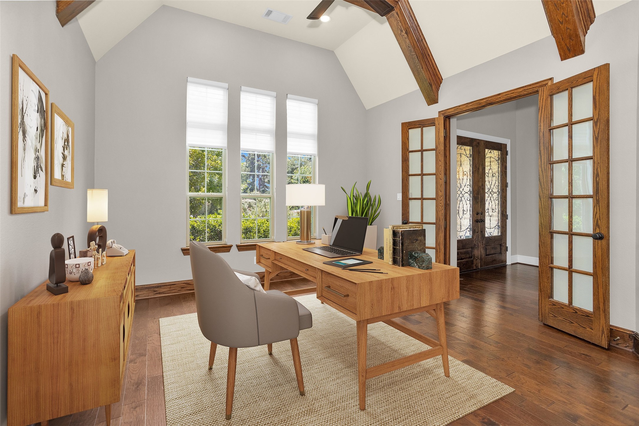 22 Marin Creek Place Spring, TX 77389 - Photo 7 of 36 Distinguished private study with custom wood built-ins, an exposed beam ceiling, and abundant natural light, creating a warm and refined space for a home office or personal library. *Virtually Staged*