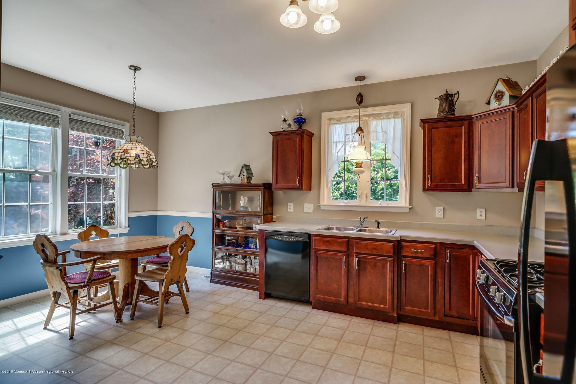 2569 Crestview Road Manasquan, NJ 08736 - Photo 17 of 35 a kitchen with a stove a sink and a refrigerator