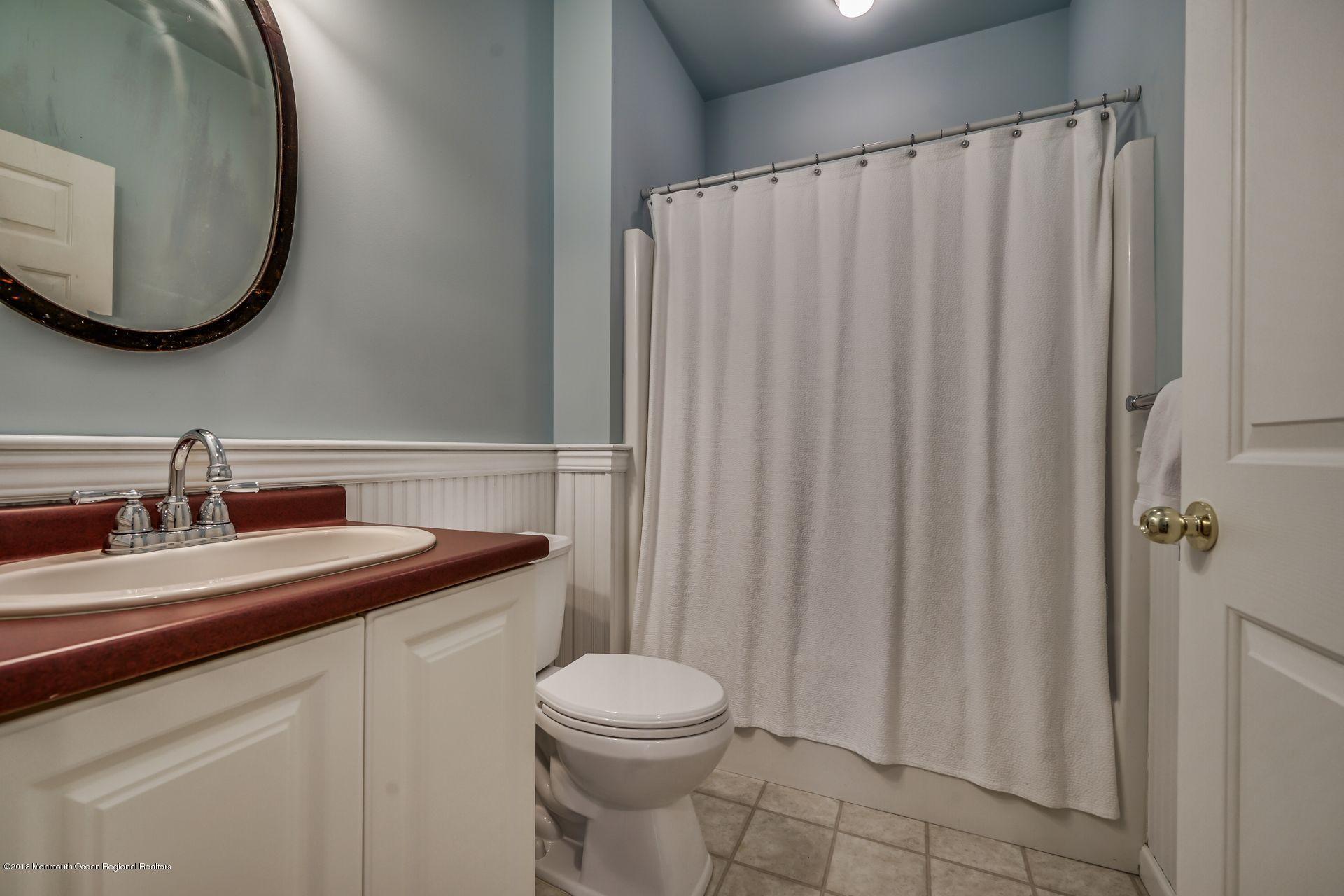 2569 Crestview Road Manasquan, NJ 08736 - Photo 25 of 35 a bathroom with a sink a toilet and mirror