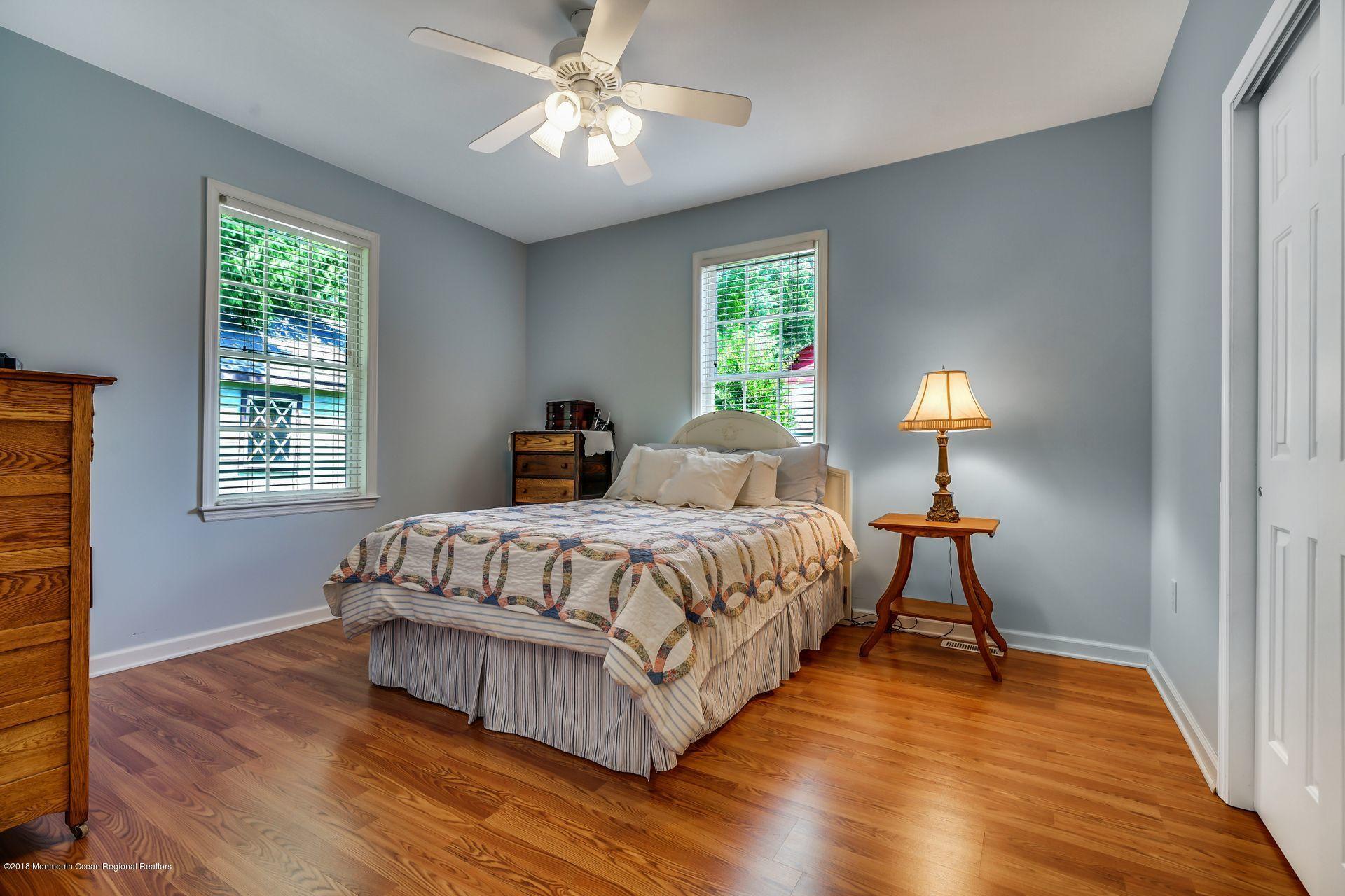 2569 Crestview Road Manasquan, NJ 08736 - Photo 28 of 35 a spacious bedroom with a bed and a window