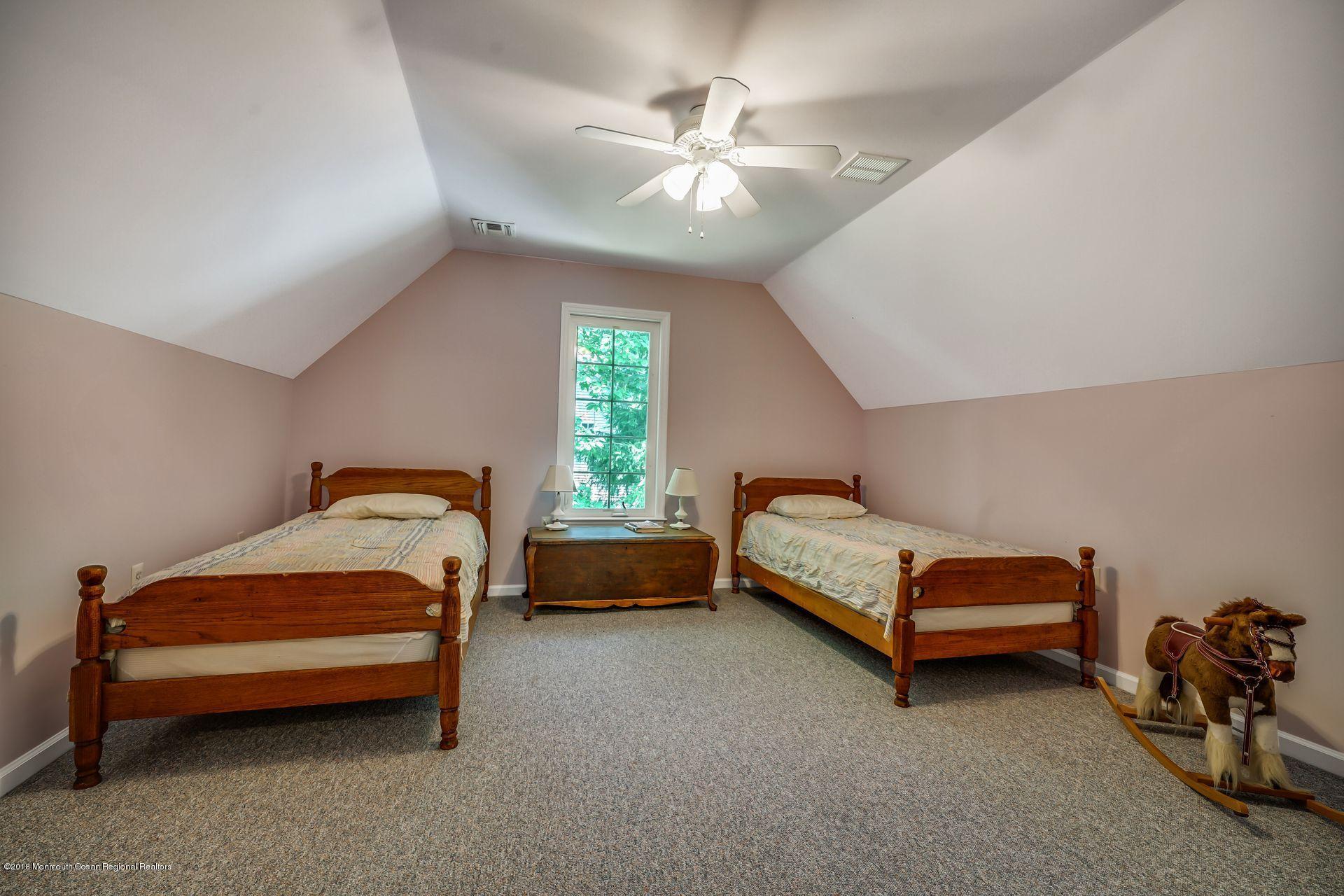 2569 Crestview Road Manasquan, NJ 08736 - Photo 29 of 35 a bedroom with furniture and a ceiling fan