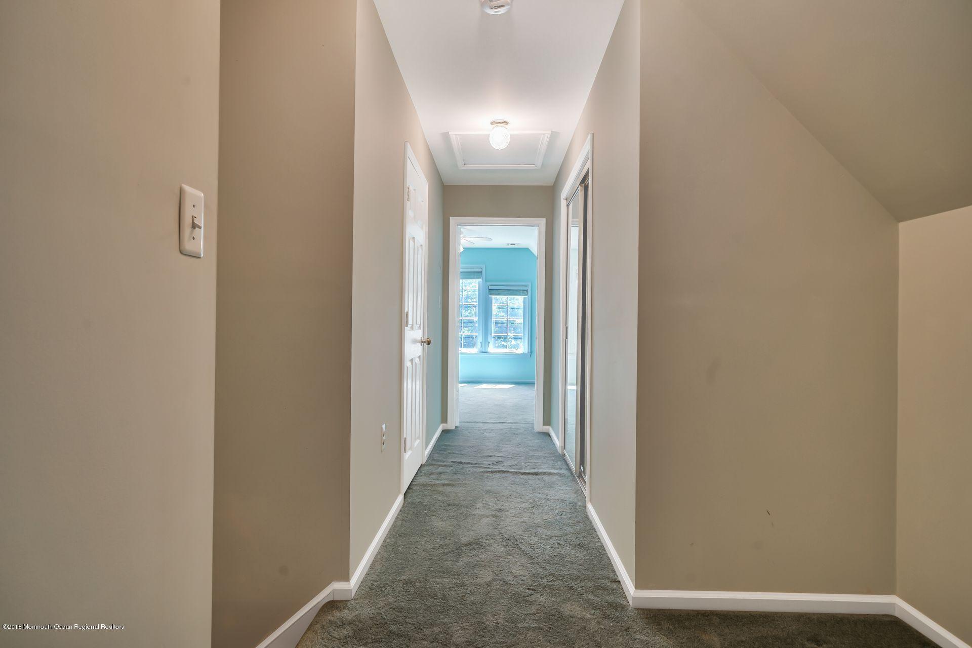 2569 Crestview Road Manasquan, NJ 08736 - Photo 30 of 35 a view of a hallway with wooden floor