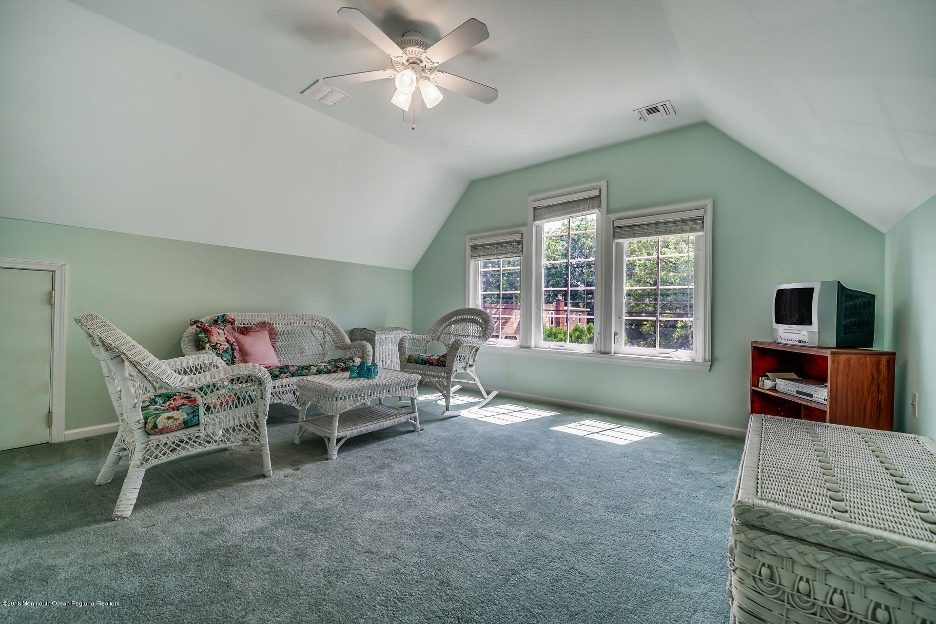 2569 Crestview Road Manasquan, NJ 08736 - Photo 31 of 35 a living room with furniture and a flat screen tv