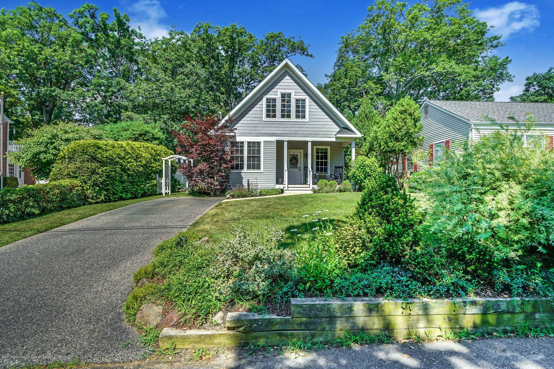 2569 Crestview Road Manasquan, NJ 08736 - Photo 4 of 35 a front view of a house with a yard and potted plants