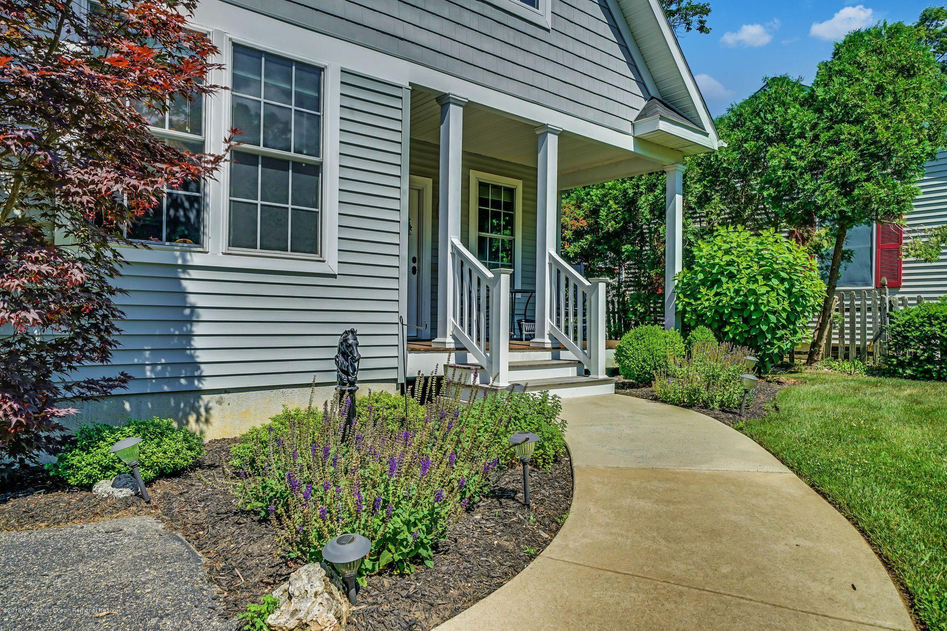 2569 Crestview Road Manasquan, NJ 08736 - Photo 8 of 35 a front view of a house with garden