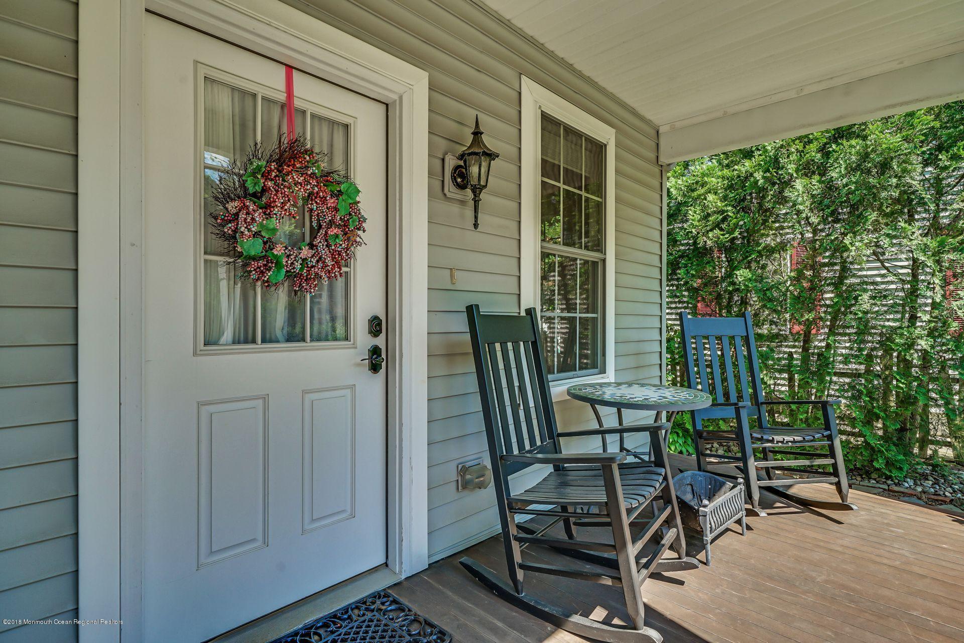 2569 Crestview Road Manasquan, NJ 08736 - Photo 10 of 35 a view of a porch with chairs and potted plants