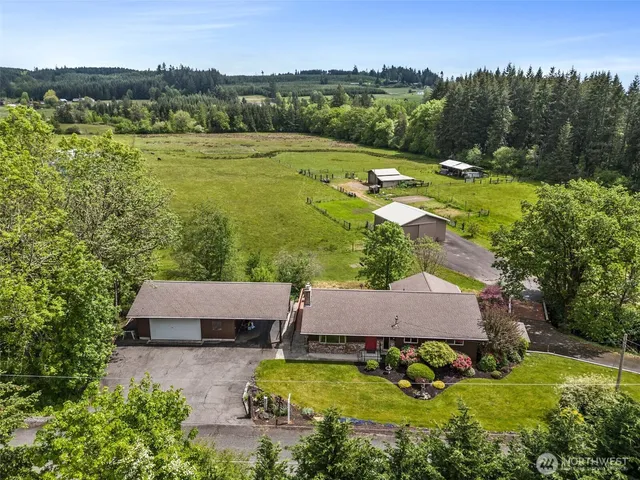 an aerial view of house with yard swimming pool and mountains