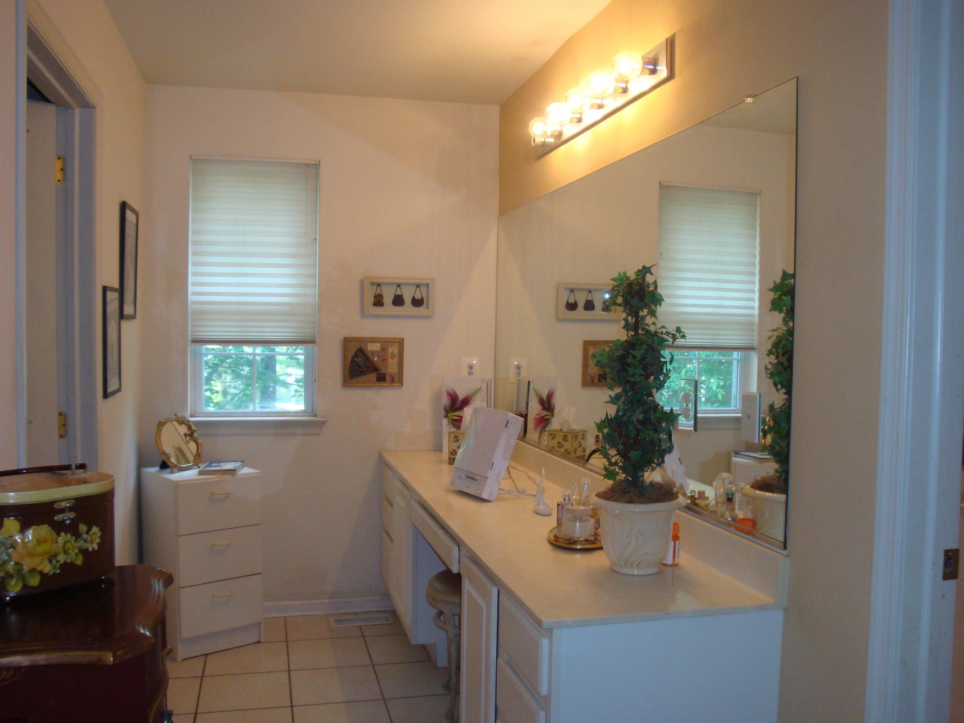 6 Devon Drive Egg Harbor Township, NJ 08234 - Photo 14 of 23 a bathroom with a sink a mirror and vanity
