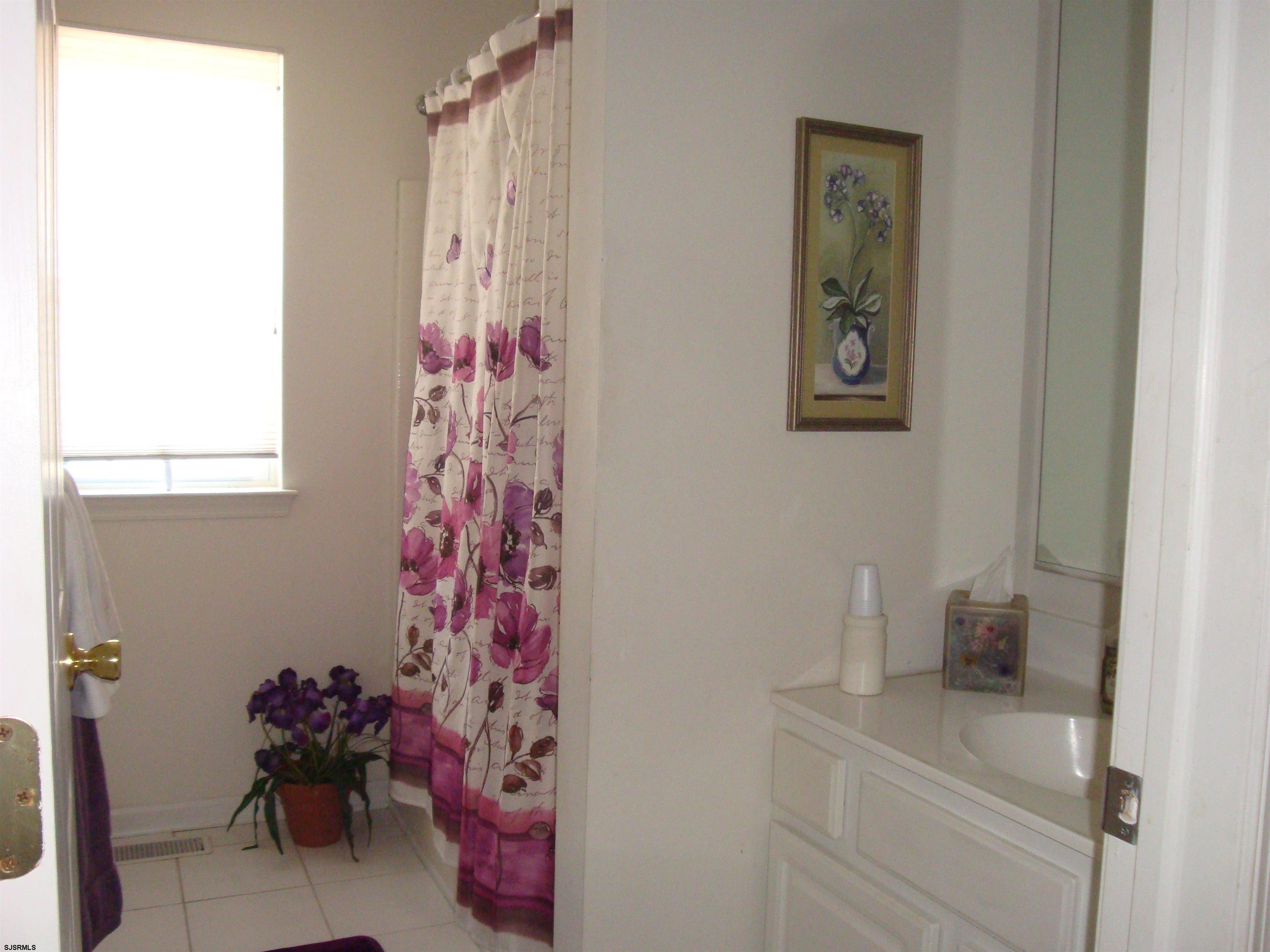 6 Devon Drive Egg Harbor Township, NJ 08234 - Photo 17 of 23 a bathroom with a shower curtain and a sink