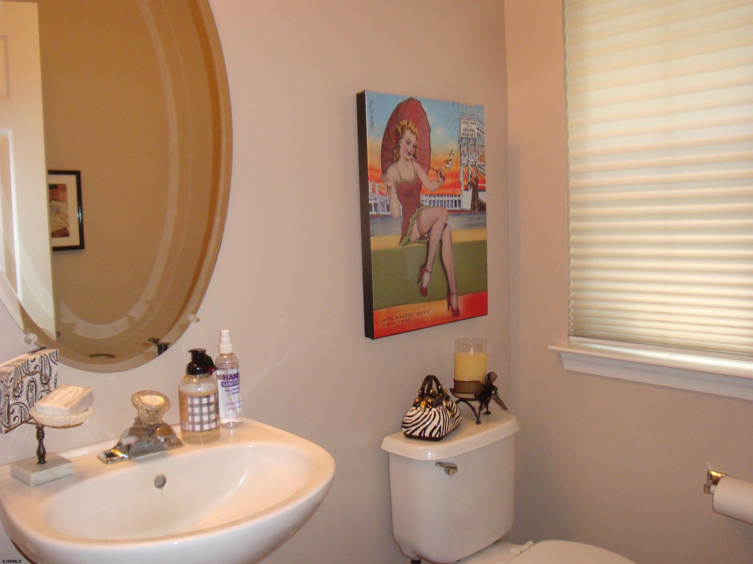 6 Devon Drive Egg Harbor Township, NJ 08234 - Photo 18 of 23 a bathroom with a sink mirror and toilet