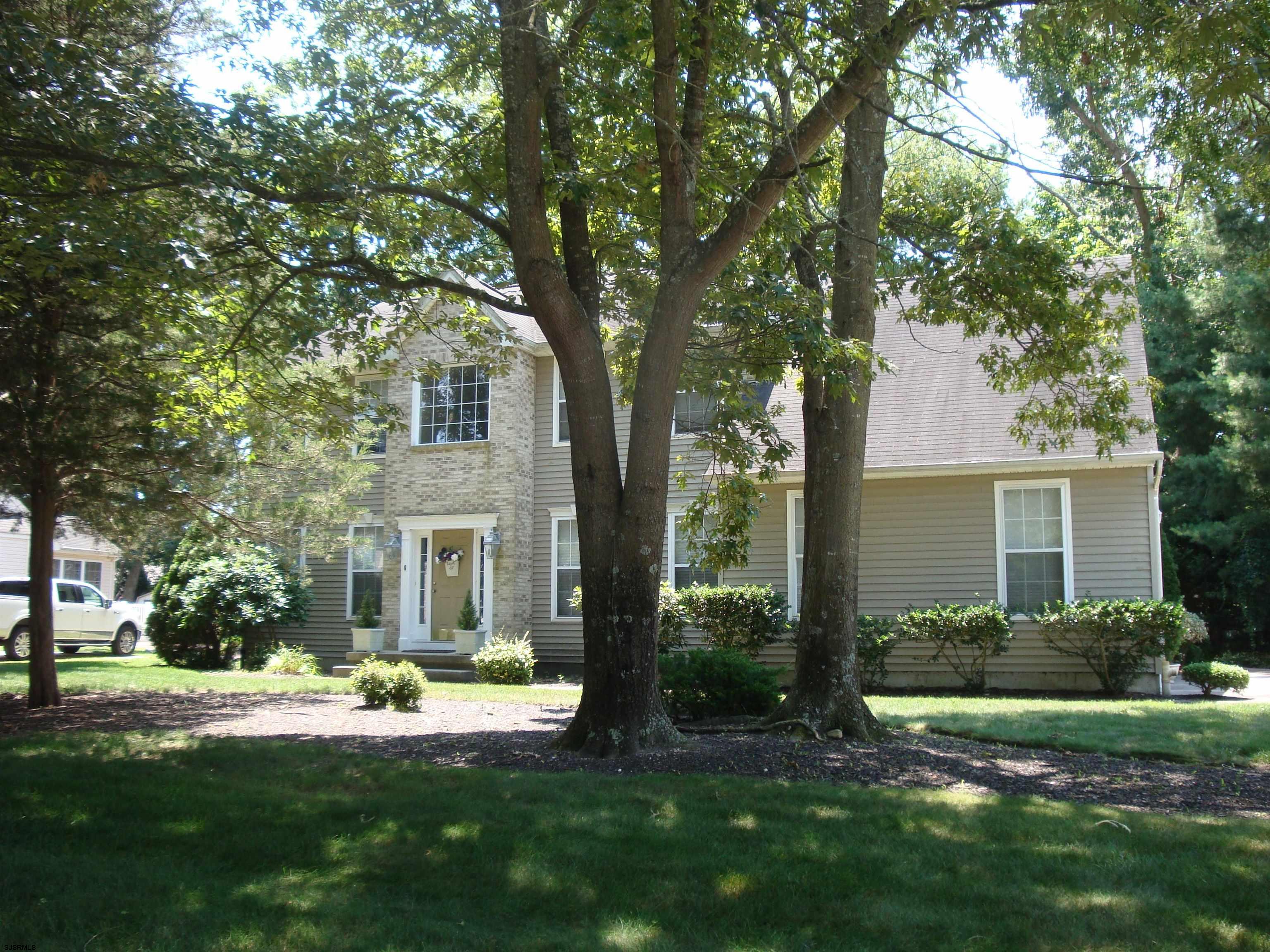 6 Devon Drive Egg Harbor Township, NJ 08234 - Photo 2 of 23 a view of a house with a yard and plants with large tree