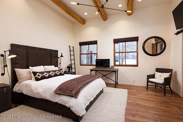 a bedroom with a bed and a chair