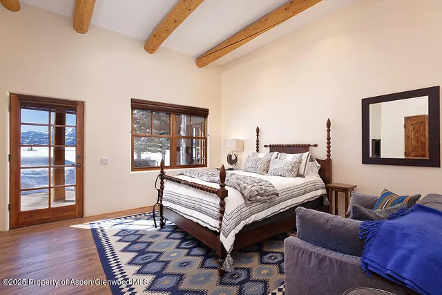 a bedroom with furniture and a window