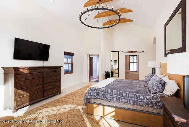 a bedroom with a bed and flat screen tv