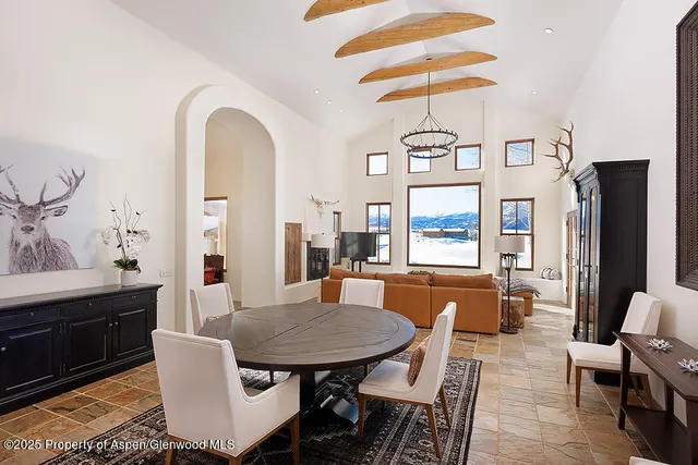 a view of a a dining room with furniture window and wooden floor