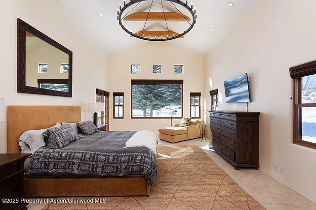 a living room with furniture a bed and a painting on the wall