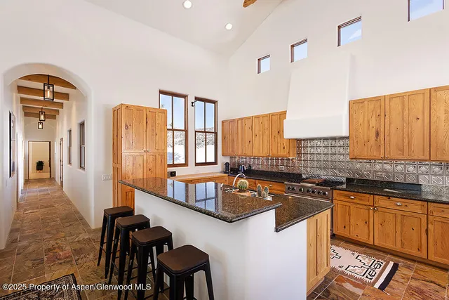 a kitchen with a sink a counter top space and stainless steel appliances