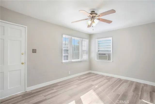 a view of a livingroom with a ceiling fan and window