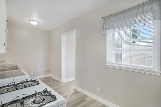 a view of a bedroom with wooden floor and a window
